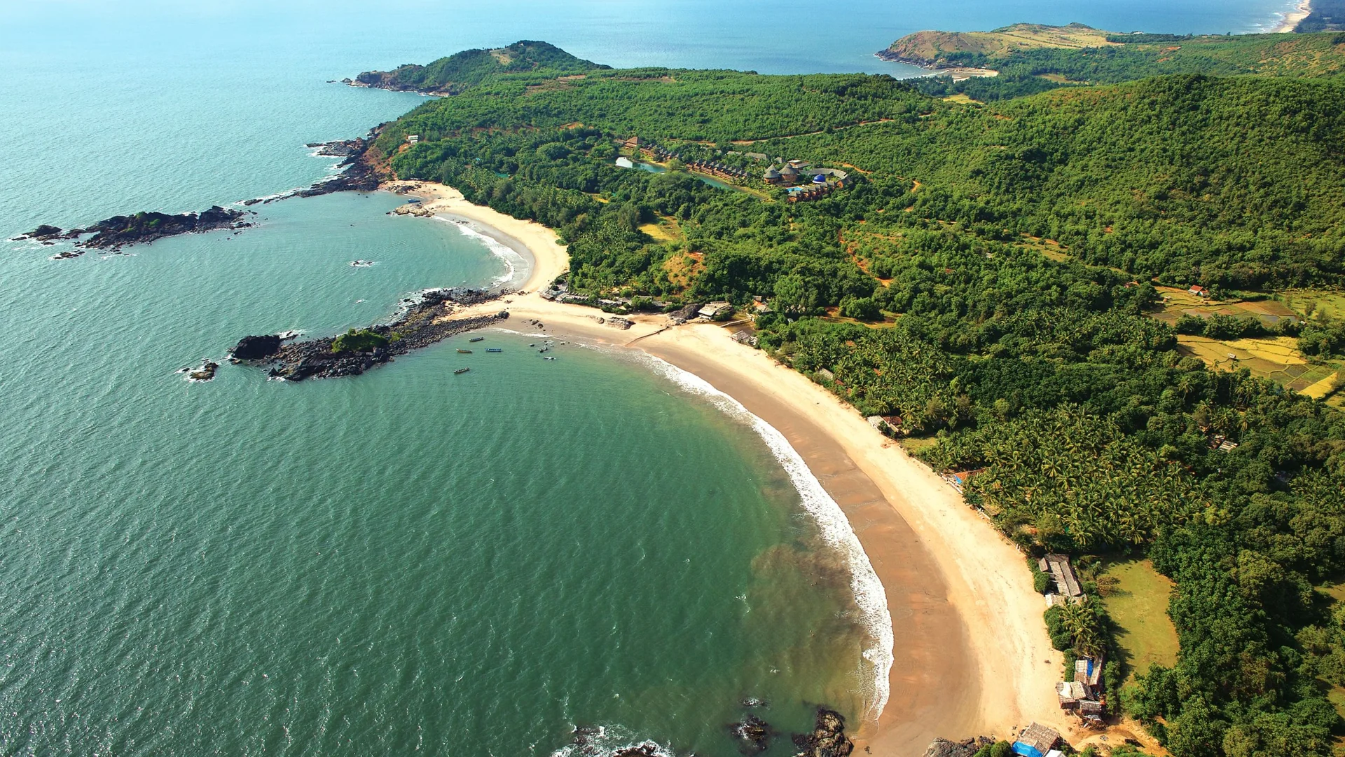 Aerial view of a forested Karnataka coastline along the Arabian Sea